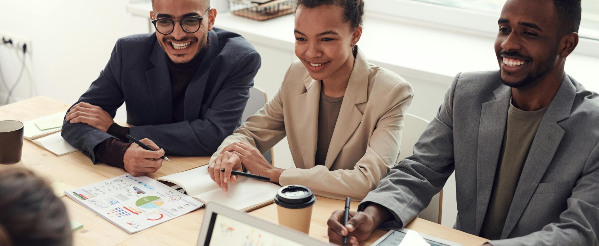 A diverse team of professionals having a meeting in a modern office setting, discussing business strategies.