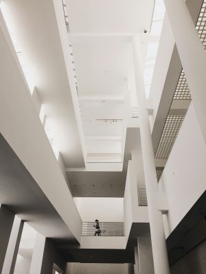 Low angle shot of a minimalist, modern interior with a person walking, great for architectural concepts.